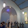 A wedding taking place in a chapel.